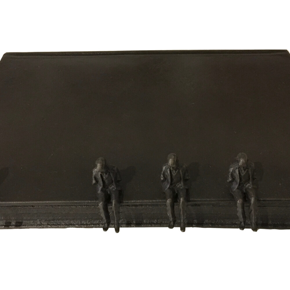 Untitled (men sitting on book)
